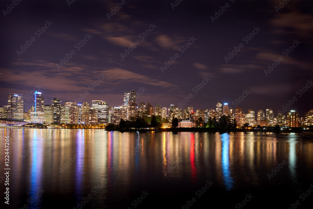Deadman's Island, Stanley Park, Vancouver. The Vancouver skyline reflects in Burrard Inlet at night. British Columbia, Canada.

