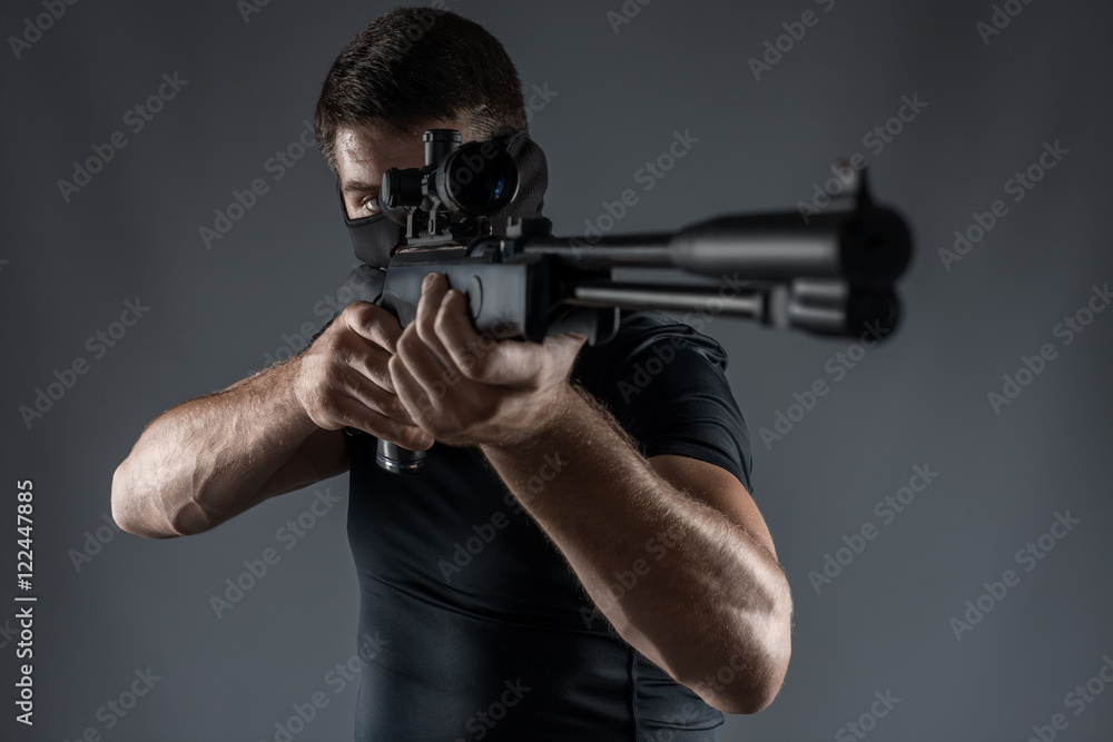 Close-ups of man with sniper rifle aiming isolated Close-ups of man with sniper rifle aiming isolated
