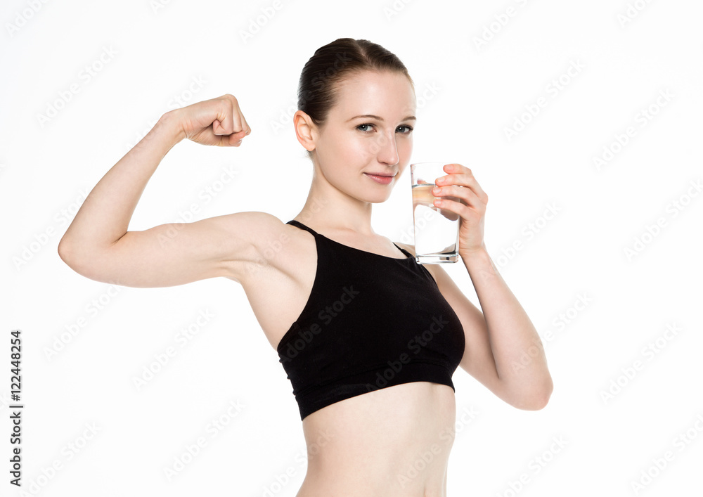 Young fitness girl drinking healthy water in gym Young fitness girl drinking healthy water in gym