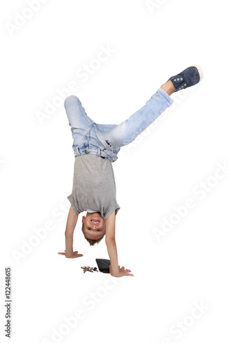 Teenage boy stands on hands above keys and wallet fell out of his pocket isolated on white background