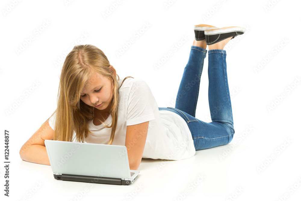 Young girl lying on the floor using laptop over white background Stock ...