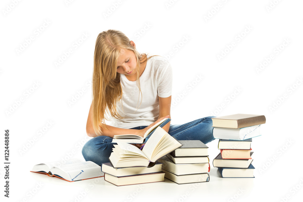 Young girl sitting on the floor with books reading over white background Young girl sitting on the floor with books reading over white background