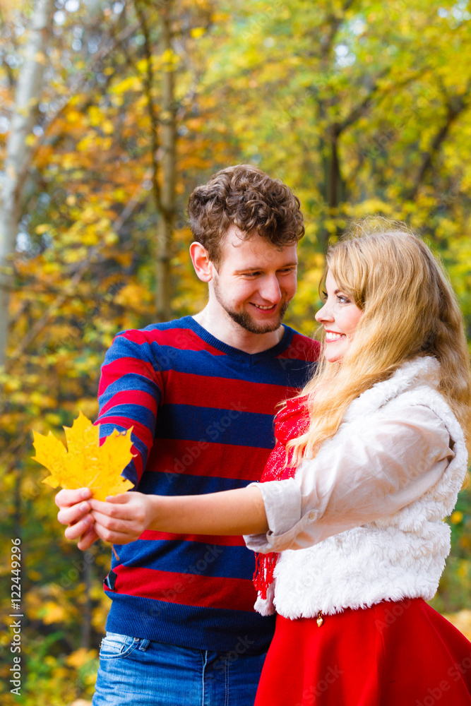 Fototapeta premium couple playing with leaf in autumn park