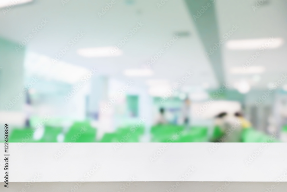 © Kwangmoozaa - Empty white desk with blur hospital background