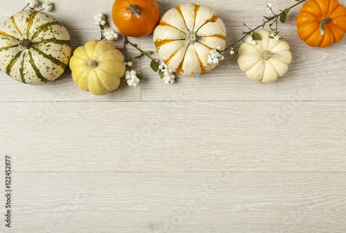 Miniature pumpkins on rustic wood background. Simple, natural country style fall autumn decorations.