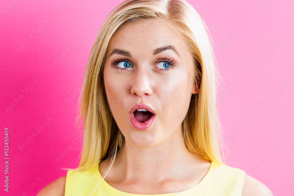 Happy young blonde woman on a pink background Happy young blonde woman on a pink background
