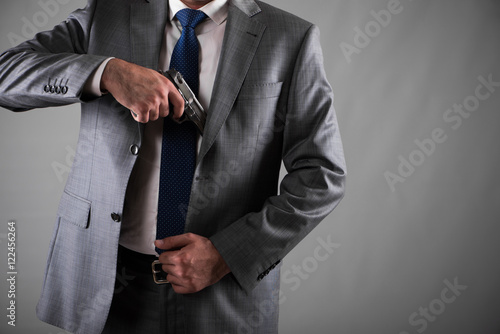 Man pulling out gun from his pocket