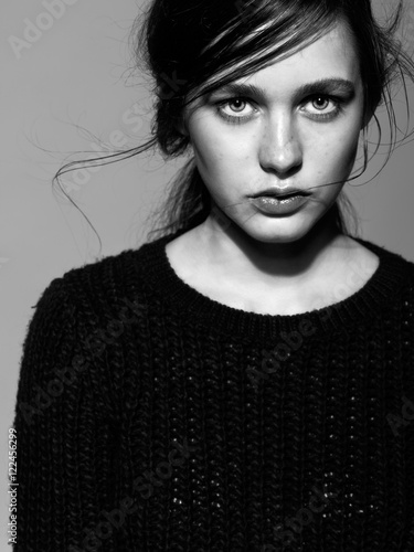 Portrait of beauty young brunette woman portrait in black fashion sweater