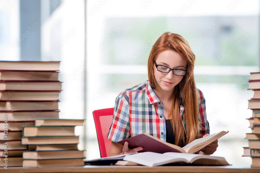 Student with stacks of books preparing for exams Student with stacks of books preparing for exams