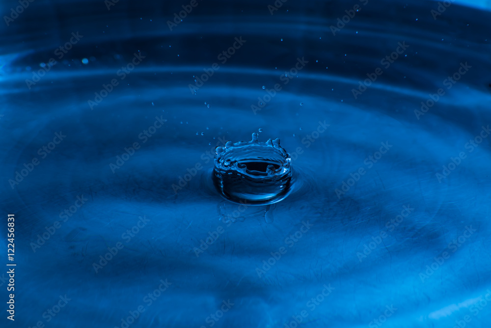 Water splash on black and blue background