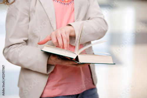 Young student reading book in preparation for exams