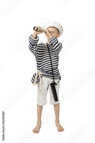 Young boy in sailor hat and frock looks through telescope isolated on white background - adventure and travel concept
