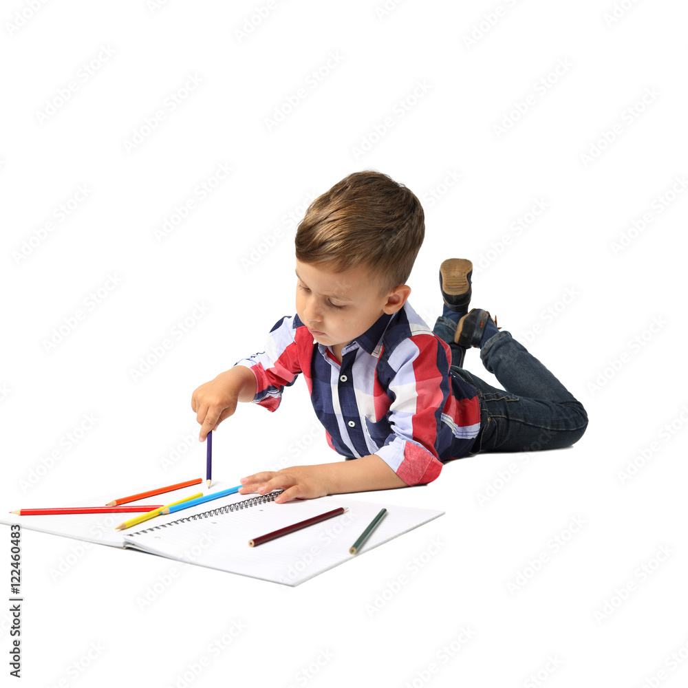 Cute Arabic looking little boy lies on floor drawing with color pencils isolated on square white background Cute Arabic looking little boy lies on floor drawing with color pencils isolated on square white background