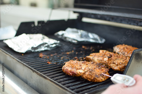 Wallpaper Mural homemade chipotle grilled chicken on the grill gets temperature taken Torontodigital.ca