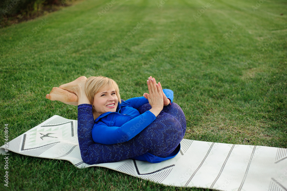beautiful woman doing yoga exercises in park beautiful woman doing yoga exercises in park