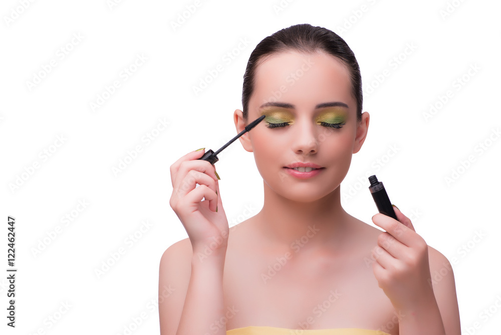 Young woman during make-up session isolated on white