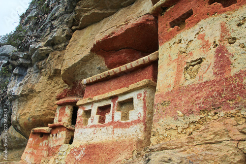 Pre inca mausoleum Revash in the mountains of northern Peru. Famous for the built in the wall and for the colorfull red and brown paintings. photo