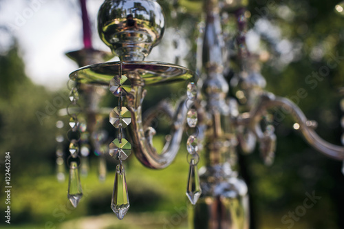 The candlesticks with violet candles  stand on the coloum photo