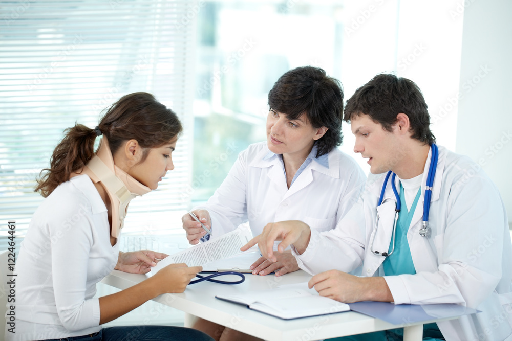 Young woman reading prescription in doctor office Young woman reading prescription in doctor office