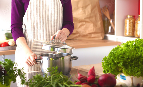 Young Woman Cooking in the kitchen. Healthy Food