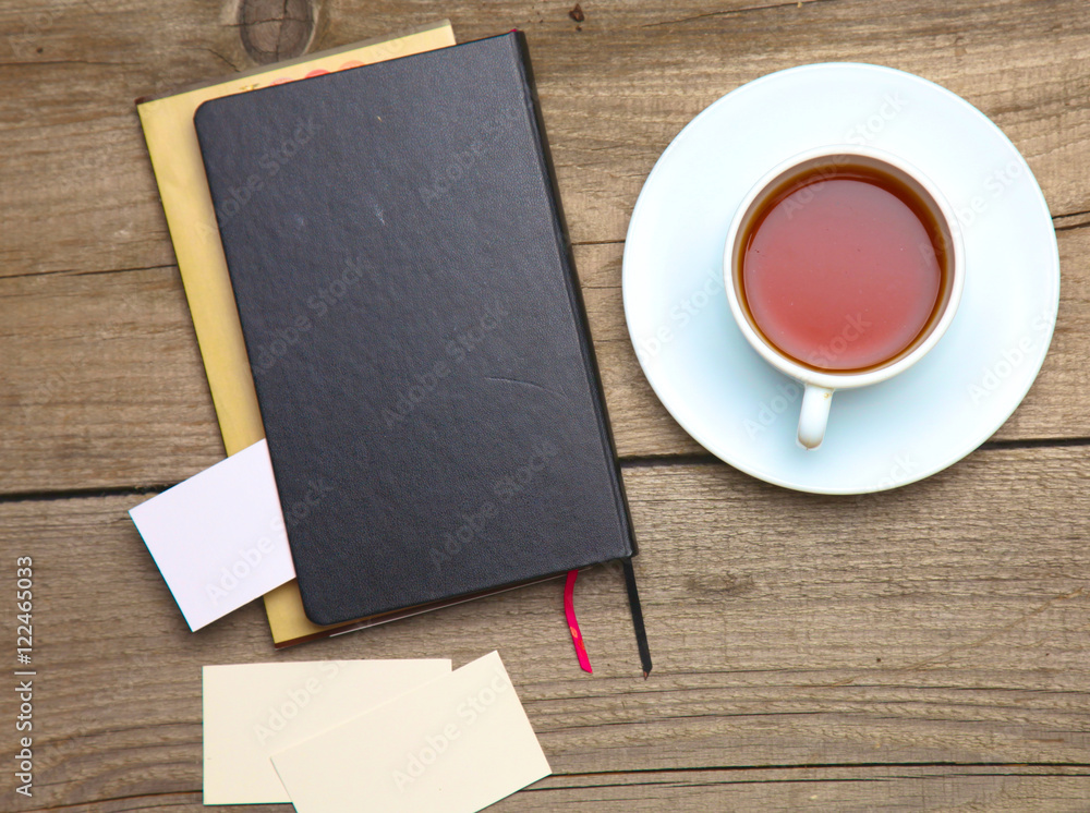 Blank business cards with pen and tea cup on wooden office table Blank business cards with pen and tea cup on wooden office table