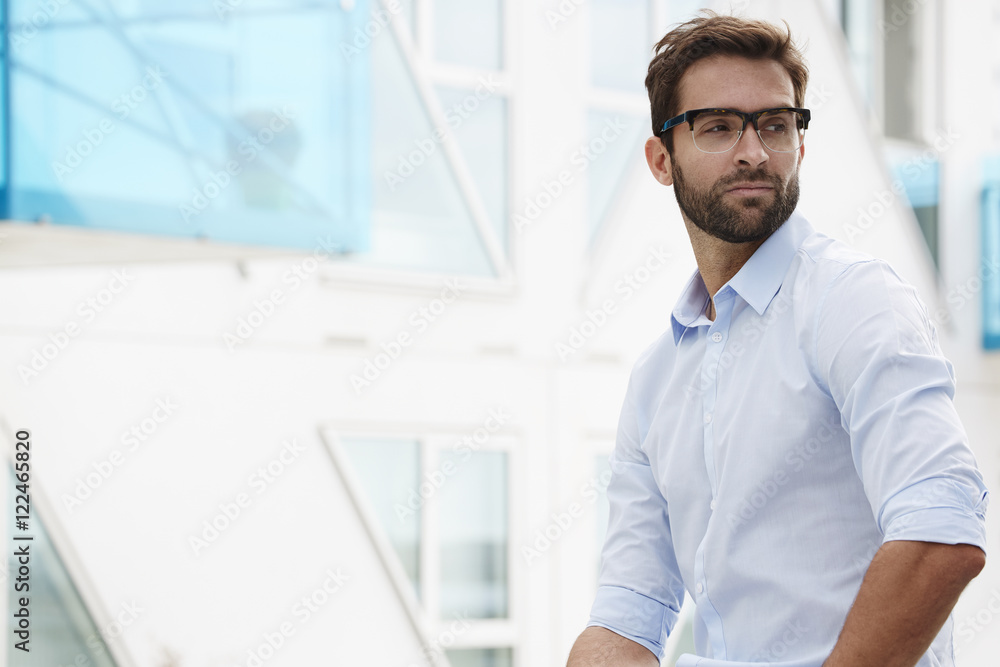Bearded guy in glasses looking over shoulder