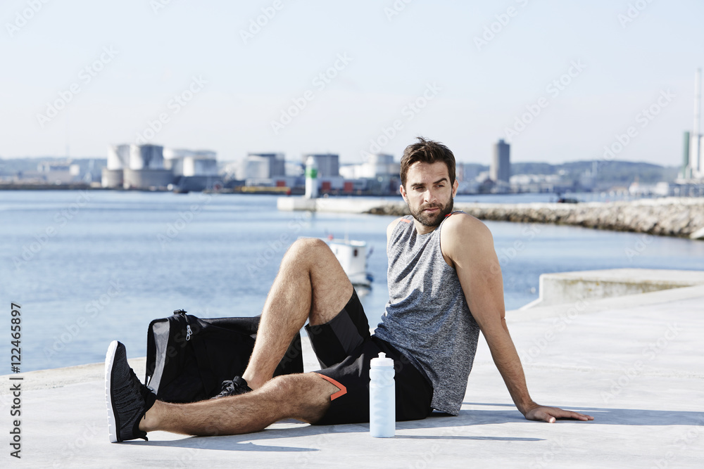 Fototapeta premium Athlete resting by sea
