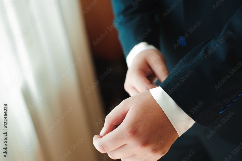 Obraz premium wedding details - elegant groom dressed wedding tuxedo costume