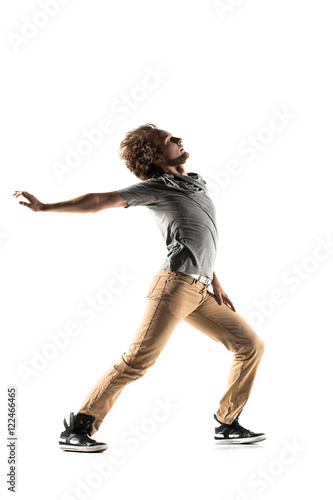 Young street style dancer posing on studio background