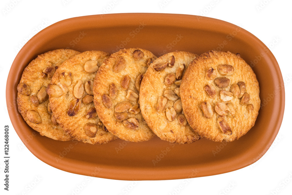 Peanut cookies in a brown plate. Isolated on white background. Peanut cookies in a brown plate. Isolated on white background.