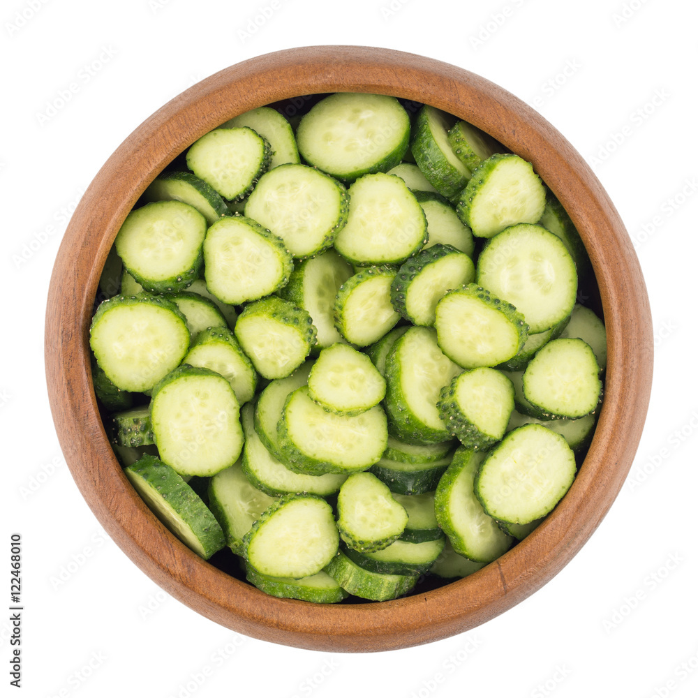 Fresh slice cucumber in wood bowl on white background Fresh slice cucumber in wood bowl on white background