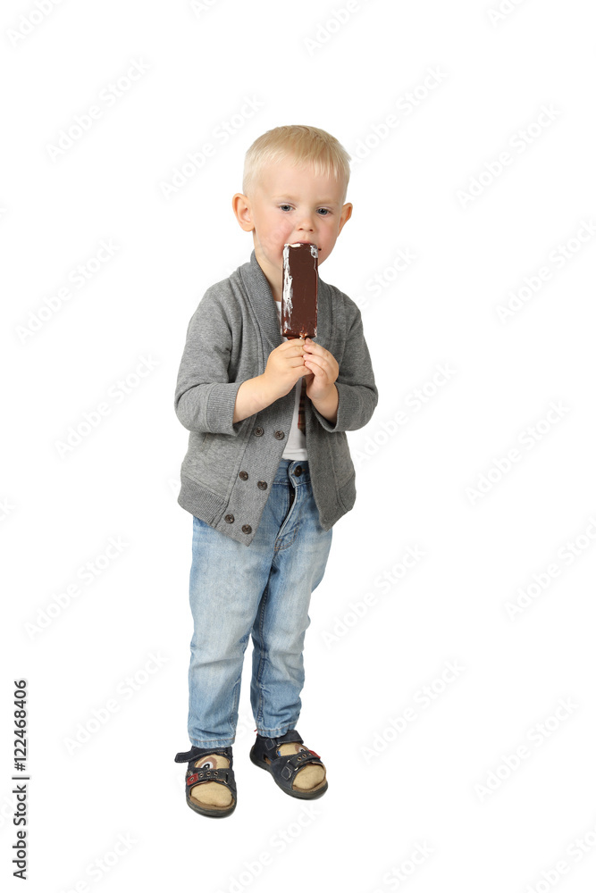 Cute little boy eats ice cream standing isolated on white background Cute little boy eats ice cream standing isolated on white background