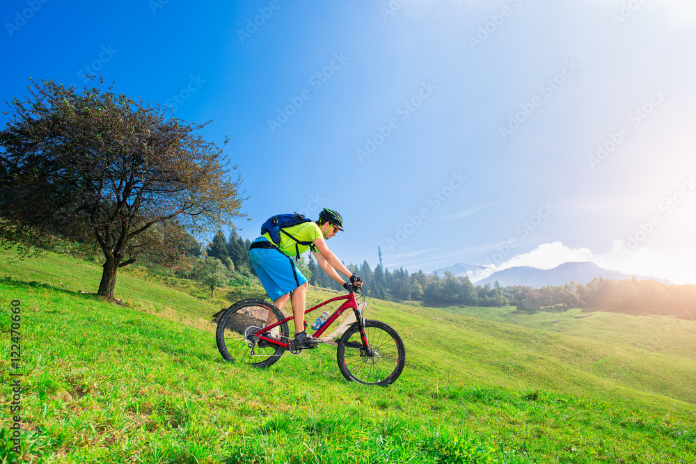 A young male riding a mountain bike downhill