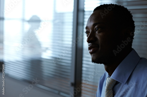 Young African businessman in office