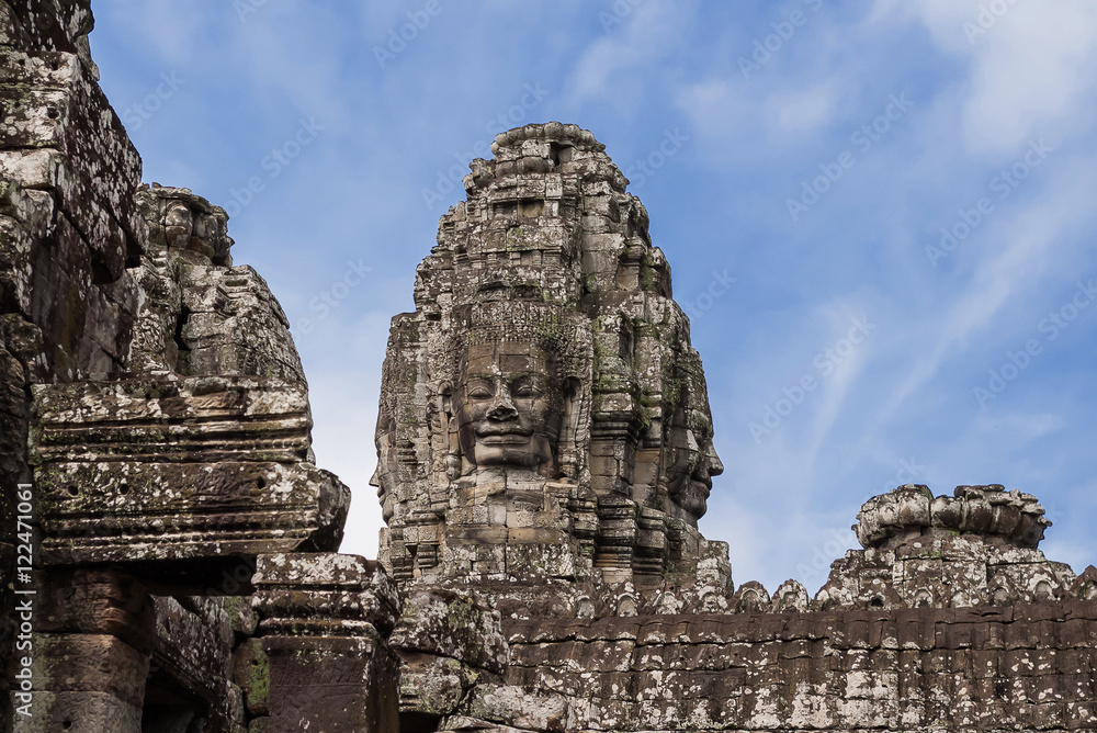 Towers with faces in Angkor Wat, temple complex in Cambodia and the largest religious monument in the world. UNESCO World Heritage Site. Towers with faces in Angkor Wat, temple complex in Cambodia and the largest religious monument in the world. UNESCO World Heritage Site.