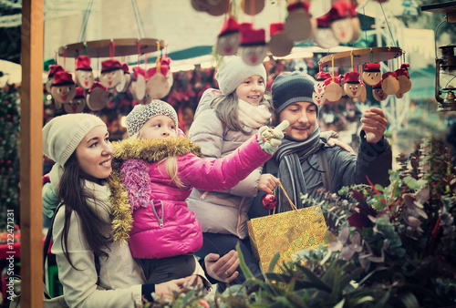 Photography Happy cheerful family of four buying Caga Tio