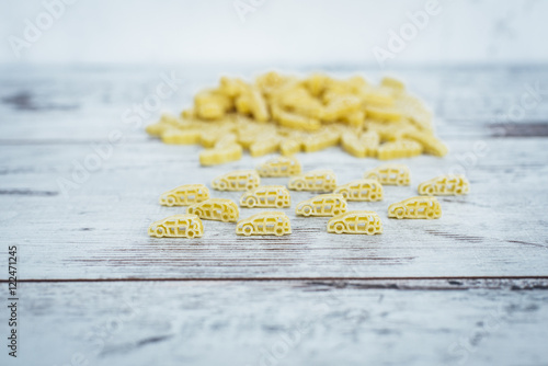 Raw car-shaped pasta in pile on wooden table © anna_rostova