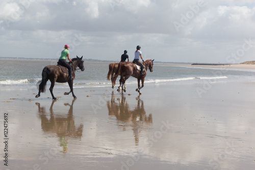 Picture of people, which is galloping on a horse of the sea at sunset © OceanProd