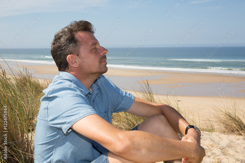 Happy man breathing deep on the beach in vacation Happy man breathing deep on the beach in vacation