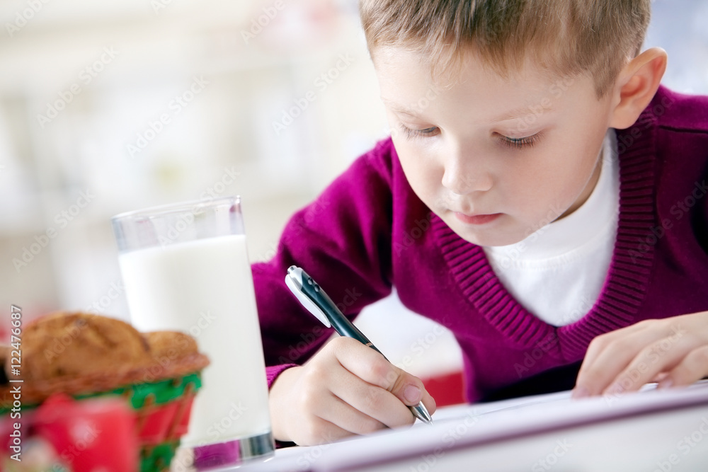 Portrait of little boy writing a letter Portrait of little boy writing a letter