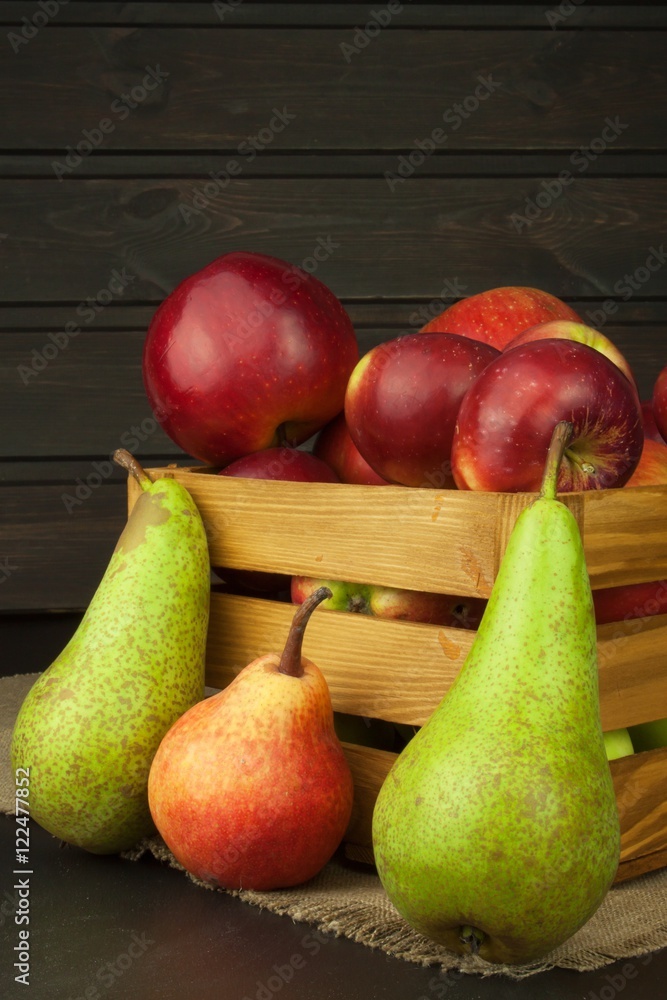 Pears and apples on wooden table. Autumn Fruits. Autumn harvest on the farm. A healthy diet for children.
