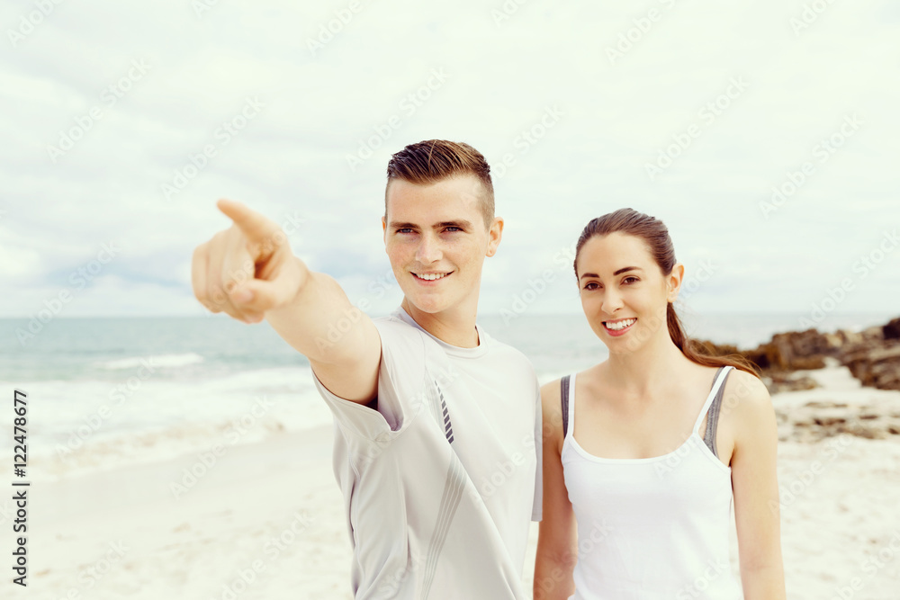 Couple of runners standing together on beach Couple of runners standing together on beach