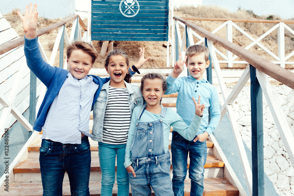 Obraz premium Fashion children on the sea shore