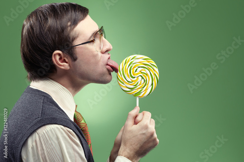 Profile of childish adult nerd sucking a lollipop 