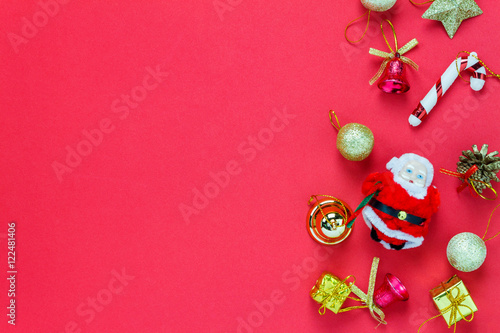 Top view Christmas decoration and Santa Claus doll on red .