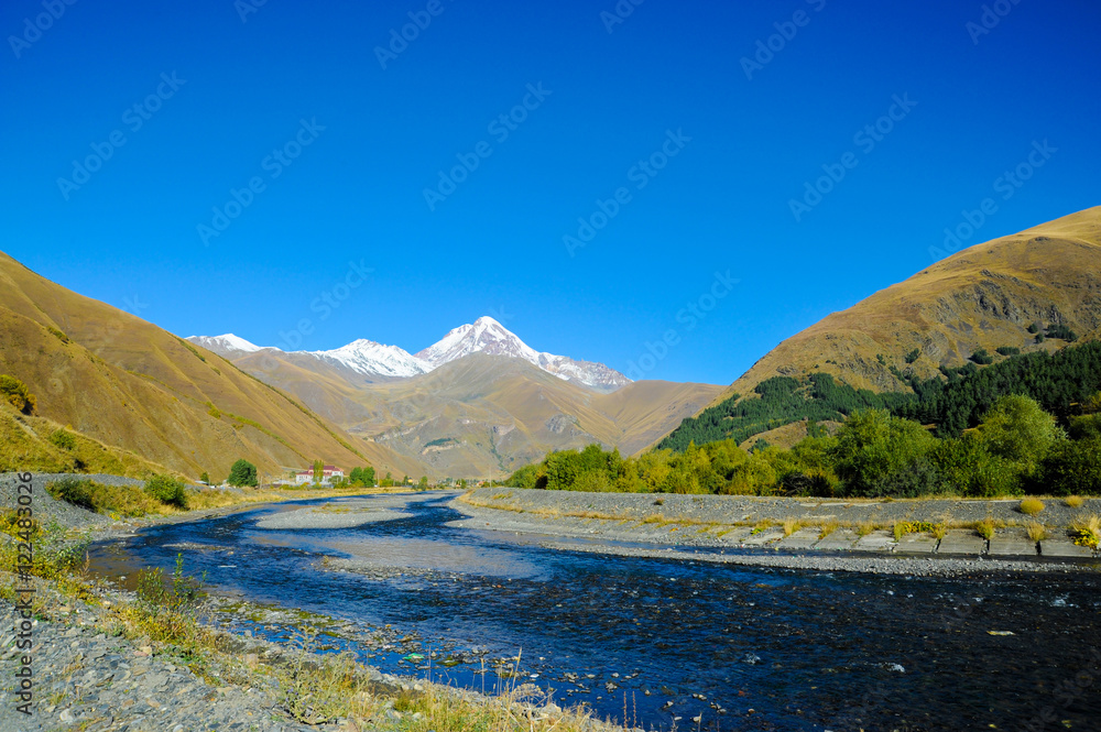 caucasus mountains in summer, Peak Mkinvari and mountain river. view from village Sno