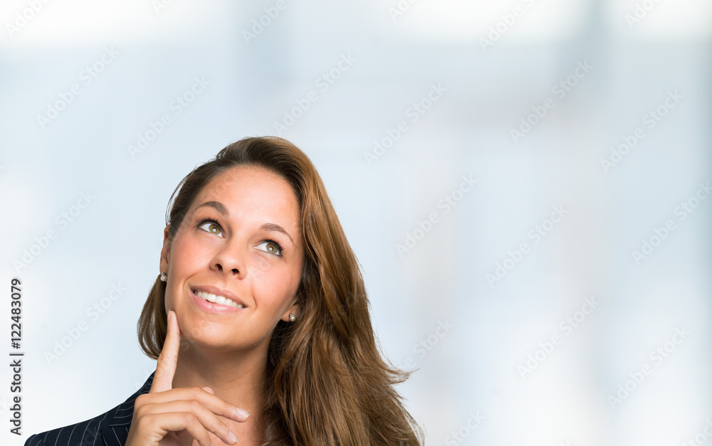 Smiling woman looking up, large copy-space