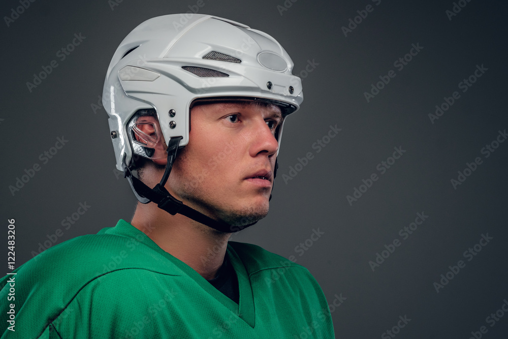 Portrait of hockey player on grey background. Portrait of hockey player on grey background.