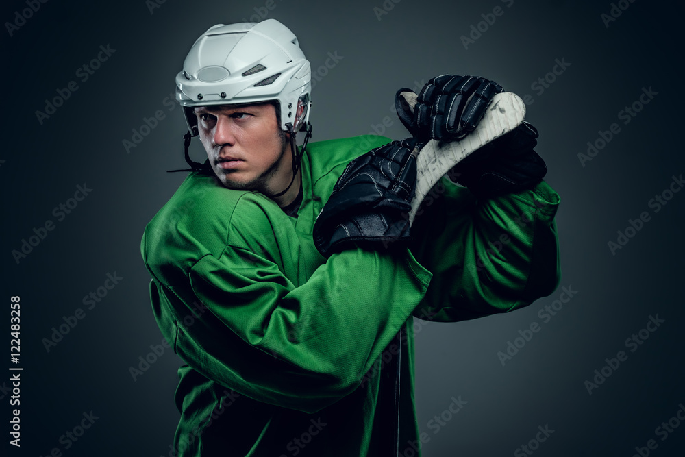 Naklejka premium Hockey player holds gaming stick.