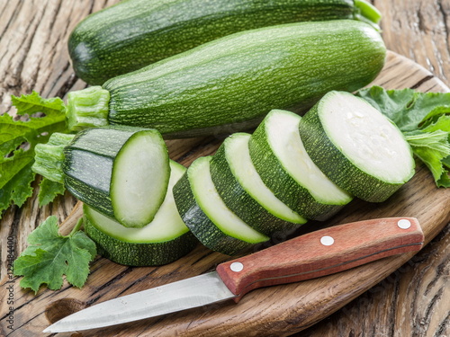 Zucchini with slices on a wooden table.